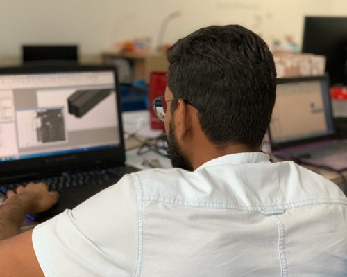 Over the shoulder view of Haskell Malaysia employee working on a structural design on a laptop computer