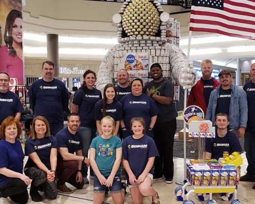 CANstruction team members pose with the award winning "Food Can Space Man" can sculpture, benefitting the Salvation Army Central Oklahoma Area Command Food Pantry.