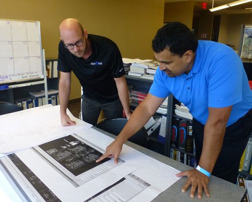 St. Louis employees discussing a drawing