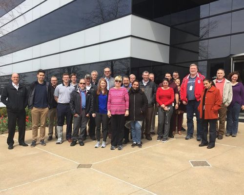 St. Louis employees pose for a group photo outside the office