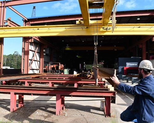 Overhead crane system handling I-beams at the Haskell Steel Shop