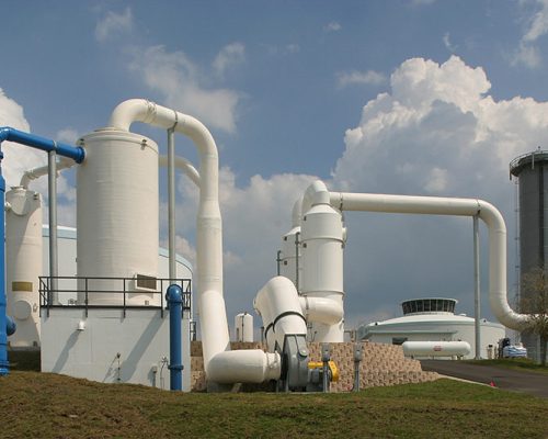 Large white storage tanks and piping outside the SMRU Water Treatment Facility
