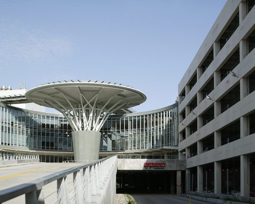 Exterior photo of emergency room entrance and parking garage at Baptist Heart Hospital.