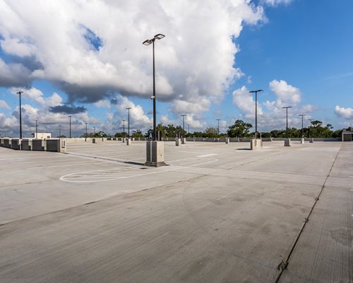 Exterior photo of top floor parking lot of parking garage.