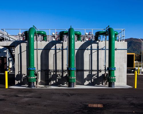 Green pipes outside the facility