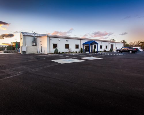 Exterior photo of the white facility with blue entry canopy