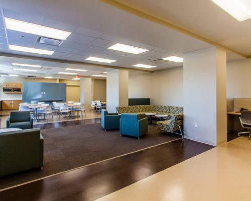 Photo of the break room at California Proton Cancer Therapy Center. Dining tables, couches, and extra comfy seating available.