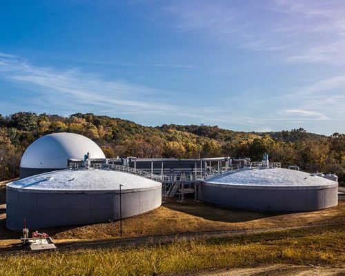 Domed grey and white wastewater processing tanks