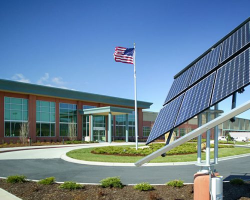 Front view of the Gatorade Bottling Facilty building with U.S. flag and solar panels