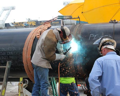 Welding crew joining pipe sections