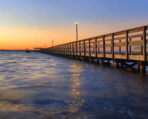 Sunset, boardwalk, and water