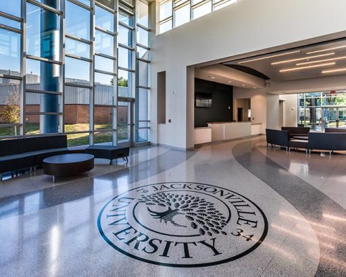 Frisch Welcome Center lobby featuring Jacksonville University logo inset in terrazzo floor