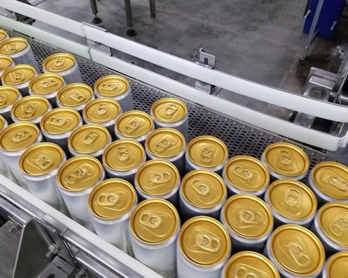 Filled seltzer cans on conveyor