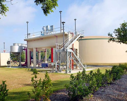 Exterior photo of water storage at the Live Oak Wastewater Treatment Plant. Staircase leads up to platform.