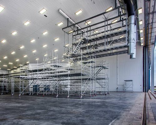 Interior of MAAS Aviation Facility hangar. Large open space with metal painting equipment.