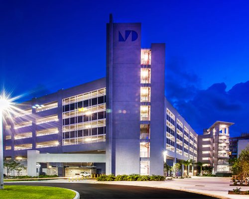 Exterior photo of parking garage at night.