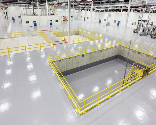 Interior of SAFRAN Aerospace Composite Facility. Large open white room with bright lights.