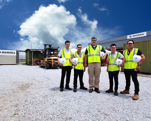Five Haskell team members standing outside of SAFRAN Landing Systems construction site.