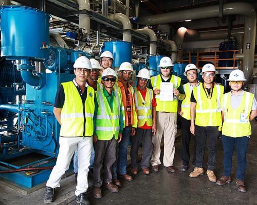 Ten Haskell team members standing inside SAFRAN Landing Systems.
