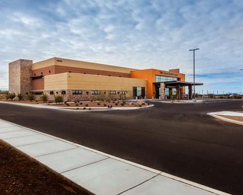 Exterior photo of TMC Rincon Health Campus. Street and parking area are in the foreground of the photo.