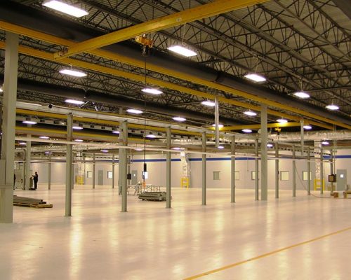 Interior of Turbomeca TMM Manufacturing Facility. Large industrial room with florescent lighting.